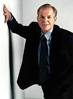 John Spencer holding up a wall